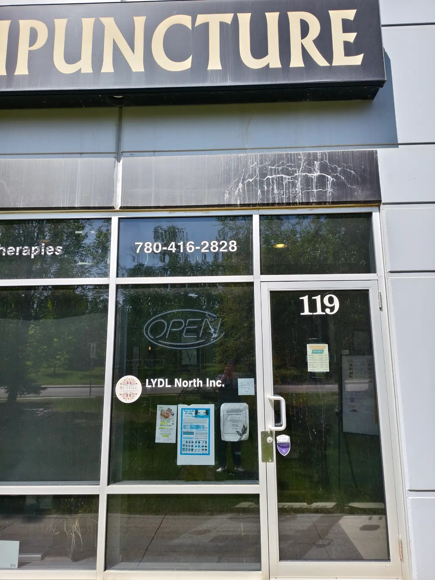 The glass entrance door marked 119 beneath the ACUPUNCTURE sign.